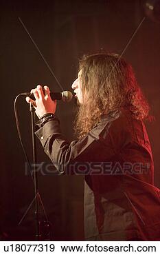 Stock Photograph - young man singing 
on stage. fotosearch 
- search stock 
photos, pictures, 
images, and photo 
clipart