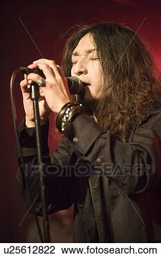 Stock Photo - young man singing 
on stage. fotosearch 
- search stock 
photos, pictures, 
images, and photo 
clipart