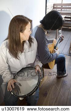 Stock Photograph - young people playing 
musical instruments. 
fotosearch - search 
stock photos, 
pictures, images, 
and photo clipart