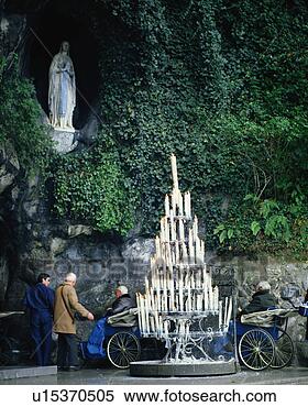 Stock Image - large group of 
candles ignited 
near virgin mary 
in lourdes, france. 
fotosearch - search 
stock photos, 
pictures, images, 
and photo clipart