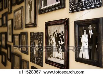Picture - antique family 
photographs covering 
wall. fotosearch 
- search stock 
photos, pictures, 
images, and photo 
clipart