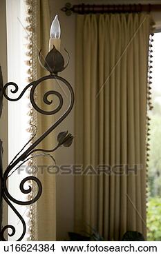 Stock Photo - detail of decorative 
wrought iron with 
light. fotosearch 
- search stock 
photos, pictures, 
images, and photo 
clipart