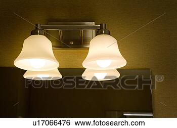 Stock Photo - wall mounted light 
fixture above 
mirror in bathroom. 
fotosearch - search 
stock photos, 
pictures, images, 
and photo clipart