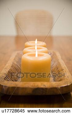 Stock Image - detail of three 
lit candles on 
wooden holder. 
fotosearch - search 
stock photos, 
pictures, images, 
and photo clipart