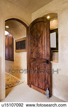 Stock Photo - detail of wooden 
door propped open 
by a small statue. 
fotosearch - search 
stock photos, 
pictures, images, 
and photo clipart