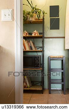 Stock Photo - vignette of kitchen 
wall unit and 
stool. fotosearch 
- search stock 
photos, pictures, 
images, and photo 
clipart