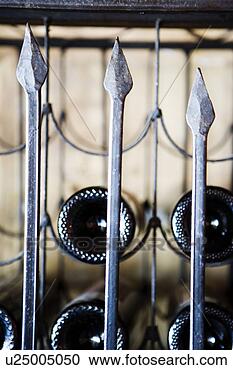 Stock Photography - wrought iron wine 
rack and bottles. 
fotosearch - search 
stock photos, 
pictures, images, 
and photo clipart