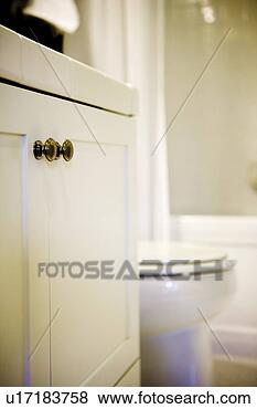 Stock Photo - white cupboard 
with chrome knobs 
in traditional 
bathroom. fotosearch 
- search stock 
photos, pictures, 
images, and photo 
clipart