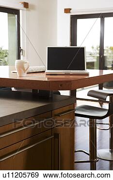 Stock Photograph - laptop and coffe 
mug on kitchen 
counter. fotosearch 
- search stock 
photos, pictures, 
images, and photo 
clipart