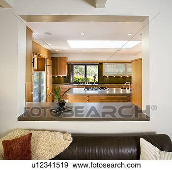 Stock Photograph - leather sofa in 
modern living 
room with cutout 
to kitchen. fotosearch 
- search stock 
photos, pictures, 
images, and photo 
clipart
