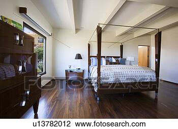 Stock Photo - minimalist modern 
bedroom with four 
post bed. fotosearch 
- search stock 
photos, pictures, 
images, and photo 
clipart