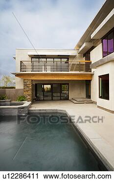 Stock Photography - rear exterior 
of modern home 
and swimming pool. 
fotosearch - search 
stock photos, 
pictures, images, 
and photo clipart