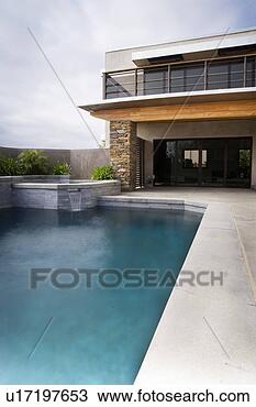 Stock Photo - rear exterior 
of modern home 
and swimming pool. 
fotosearch - search 
stock photos, 
pictures, images, 
and photo clipart