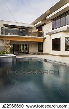 Stock Photography - rear exterior 
of modern home 
and swimming pool. 
fotosearch - search 
stock photos, 
pictures, images, 
and photo clipart