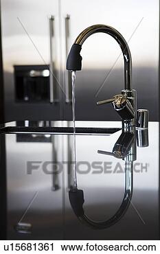 Stock Photography - running water 
from faucet with 
reflection. fotosearch 
- search stock 
photos, pictures, 
images, and photo 
clipart
