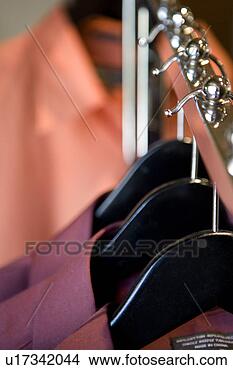 Stock Photo - store display 
of collared dress 
shirts hanging 
from chrome rack. 
fotosearch - search 
stock photos, 
pictures, images, 
and photo clipart