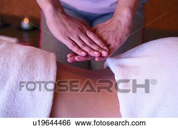 Stock Photo - person receiving 
back massage, 
side view, close-up. 
fotosearch - search 
stock photos, 
pictures, images, 
and photo clipart