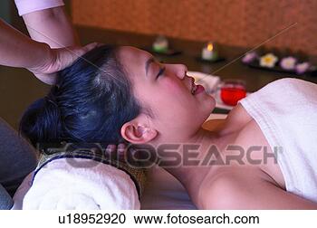 Stock Photography - young woman having 
neck massaged, 
eyes closed, close-up, 
side view. fotosearch 
- search stock 
photos, pictures, 
images, and photo 
clipart
