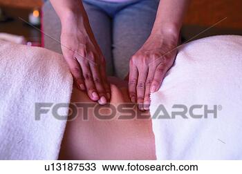Stock Photo - young woman massage 
therapist rubbing 
woman's back. 
fotosearch - search 
stock photos, 
pictures, images, 
and photo clipart
