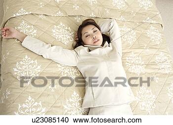 Stock Photography - woman liying in 
a bed. fotosearch 
- search stock 
photos, pictures, 
images, and photo 
clipart