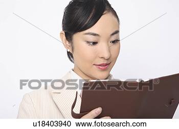 Stock Photography - business lady 
checking a notebook. 
fotosearch - search 
stock photos, 
pictures, images, 
and photo clipart