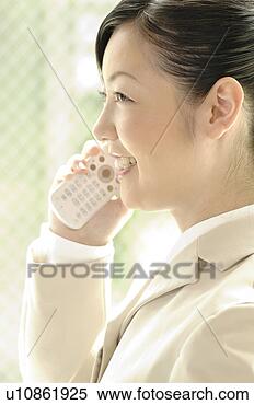 Stock Image - business lady 
who speaks with 
the cell phone. 
fotosearch - search 
stock photos, 
pictures, images, 
and photo clipart