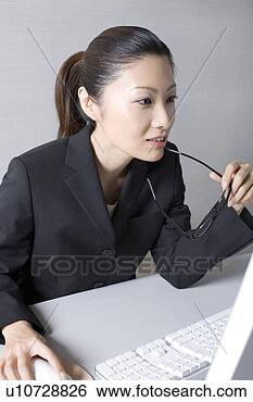 Stock Photo - woman operating 
a pc. fotosearch 
- search stock 
photos, pictures, 
images, and photo 
clipart