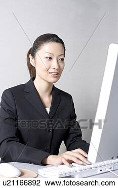 Stock Photo - woman operating 
a pc. fotosearch 
- search stock 
photos, pictures, 
images, and photo 
clipart