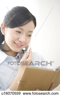 Stock Photograph - woman talking 
on cell phone 
in business. fotosearch 
- search stock 
photos, pictures, 
images, and photo 
clipart