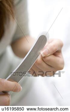 Stock Photography - woman doing care 
of her nail. fotosearch 
- search stock 
photos, pictures, 
images, and photo 
clipart