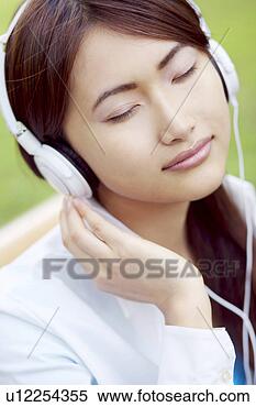 Stock Image - woman who hangs 
upon the music. 
fotosearch - search 
stock photos, 
pictures, images, 
and photo clipart