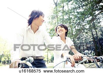 Stock Image - couple who enjoys 
a cycling. fotosearch 
- search stock 
photos, pictures, 
images, and photo 
clipart