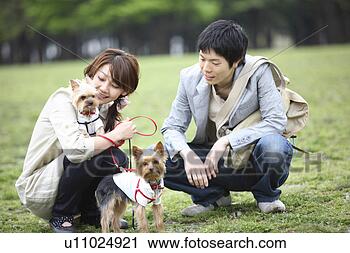 Stock Photography - couple taking 
a walk with the 
dog. fotosearch 
- search stock 
photos, pictures, 
images, and photo 
clipart