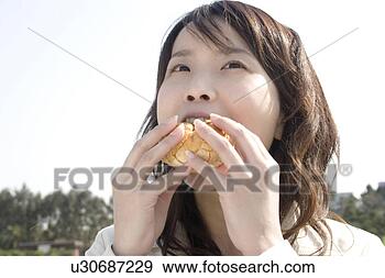 Stock Photograph - woman who eats 
lunch. fotosearch 
- search stock 
photos, pictures, 
images, and photo 
clipart