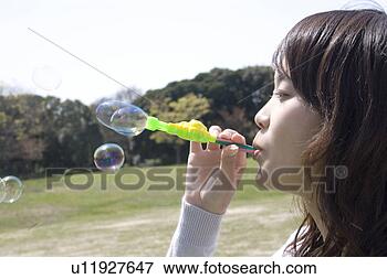 Picture - woman who plays 
with the soap 
bubble. fotosearch 
- search stock 
photos, pictures, 
images, and photo 
clipart