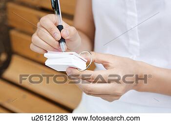 Stock Photo - woman who writes 
in the word notebook. 
fotosearch - search 
stock photos, 
pictures, images, 
and photo clipart