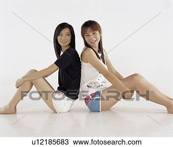 Stock Photo - a portrait of 
two sitting young 
women. fotosearch 
- search stock 
photos, pictures, 
images, and photo 
clipart