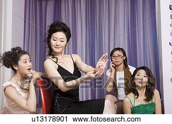 Stock Photography - three young woman 
looking at finger 
nails of other. 
fotosearch - search 
stock photos, 
pictures, images, 
and photo clipart