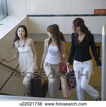 Stock Photo - three young women 
upstairs with 
bags. fotosearch 
- search stock 
photos, pictures, 
images, and photo 
clipart