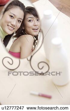 Picture - two young women 
looking into mirror. 
fotosearch - search 
stock photos, 
pictures, images, 
and photo clipart