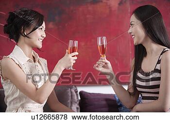 Stock Photo - young women drinking 
wine, smiling. 
fotosearch - search 
stock photos, 
pictures, images, 
and photo clipart