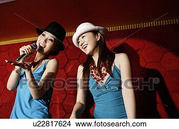 Stock Photo - young women singing. 
fotosearch - search 
stock photos, 
pictures, images, 
and photo clipart