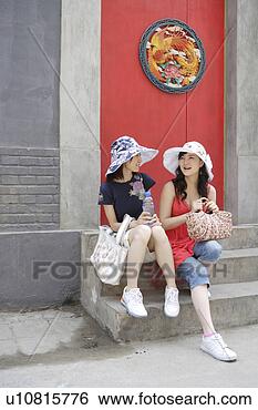 Stock Photo - young women sitting 
with bags. fotosearch 
- search stock 
photos, pictures, 
images, and photo 
clipart