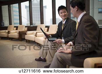 Stock Photo - office men looking 
at laptop in sofa. 
fotosearch - search 
stock photos, 
pictures, images, 
and photo clipart