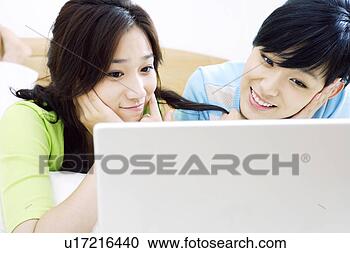 Stock Photography - two young women 
in bed with laptop. 
fotosearch - search 
stock photos, 
pictures, images, 
and photo clipart