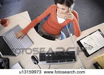 Stock Photo - women on the phone 
at the desk. fotosearch 
- search stock 
photos, pictures, 
images, and photo 
clipart