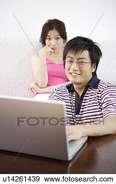 Stock Photograph - young couple in 
sofa with laptop. 
fotosearch - search 
stock photos, 
pictures, images, 
and photo clipart