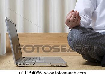 Stock Photo - young man sitting 
with laptop. fotosearch 
- search stock 
photos, pictures, 
images, and photo 
clipart
