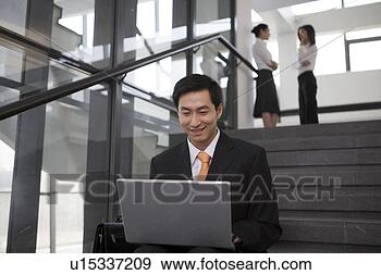 Stock Photograph - young man sitting 
on stairs with 
laptop. fotosearch 
- search stock 
photos, pictures, 
images, and photo 
clipart