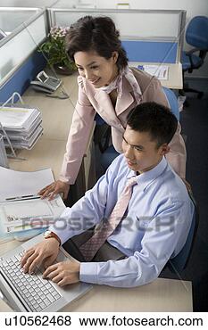 Stock Photo - young man and 
young woman looking 
at laptop in office. 
fotosearch - search 
stock photos, 
pictures, images, 
and photo clipart